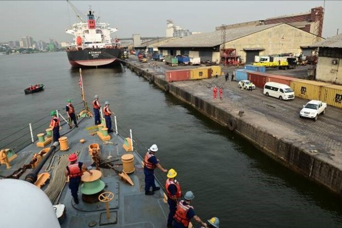 The crew of USCGC Spencer (WMEC 905) watch as the cutter moors in Abidjan, Côte d’Ivoire, Feb. 16, 2023. Spencer is on a scheduled deployment in the U.S. Naval Forces Africa area of responsibility, employed by the U.S. Sixth Fleet, to carry out joint training, exercises, and maritime security operations alongside African partners in support of U.S. interests abroad, regional partnerships, and to strengthen international maritime governance. (U.S. Coast Guard photo by Petty Officer 3rd Class Mikaela McGee)