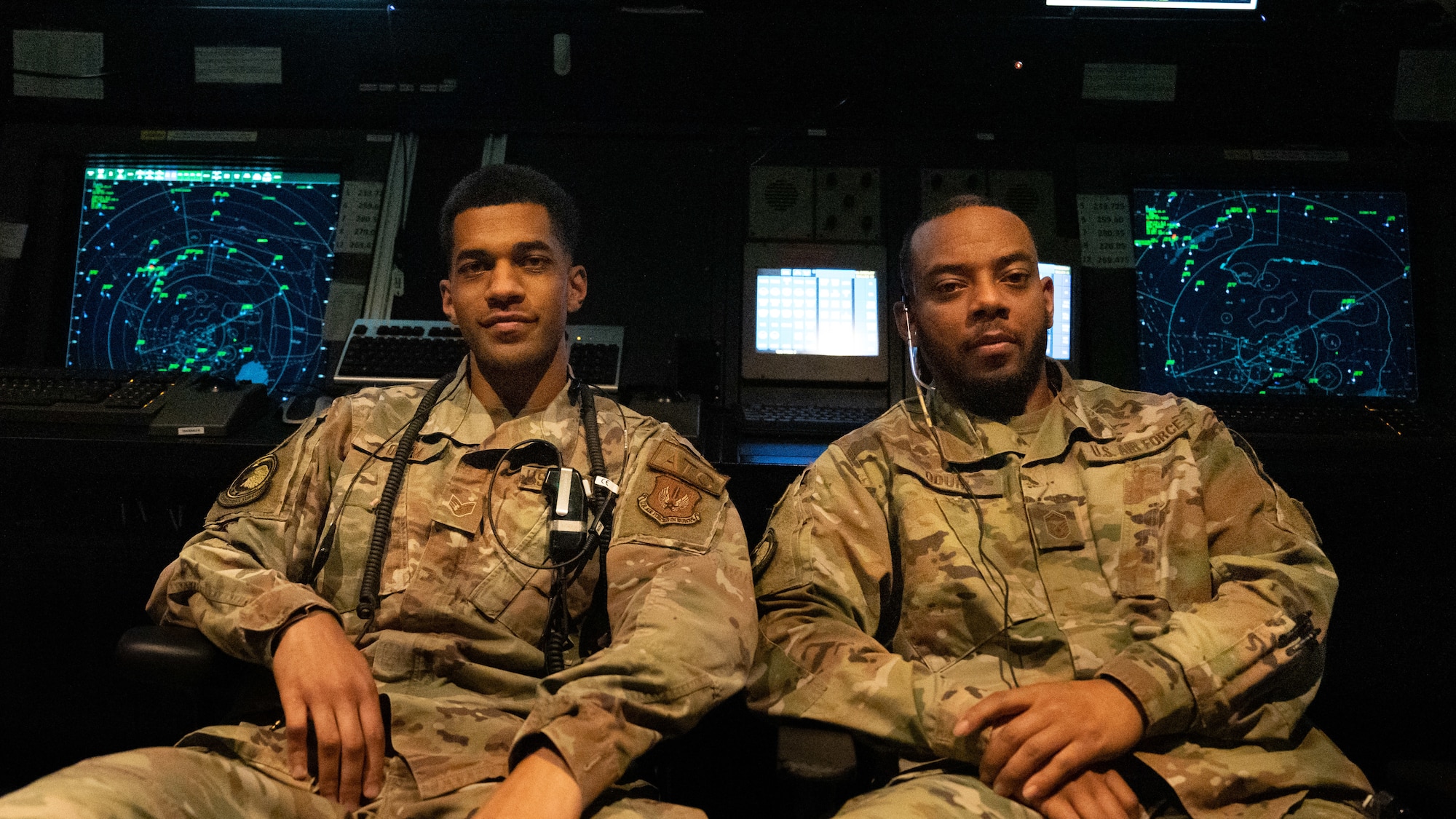 Master Sgt. L'Aaron Odum and Staff Sgt. Nieko Odum sit side by side.