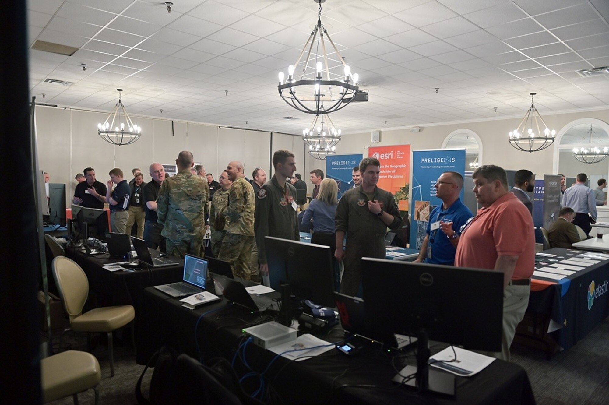 U.S. Air Force members discuss the capabilities presented at industry partners' booths during Innovation Day at Shaw Air Force Base, S.C., Feb. 15, 2023. This was the first Innovation Day hosted by 9 AF (AFCENT).  More than 70 industry partners and 230 participants attended the event designed to connect the organization with solutions to problem sets in their 21-country area of responsibility.