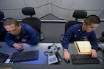 A Coast Guard Information Systems Technician adjusts cables inside a server room at the Telecommunication and Information Systems Command (TISCOM) Jan. 24, 2013. ITs are responsible for establishing and maintaining Coast Guard computer systems, analog and digital voice systems (telephones and voicemail), and installing and maintaining the physical network infrastructure that ties the systems together. U.S. Coast Guard photo by Petty Officer 2nd Class Etta Smith