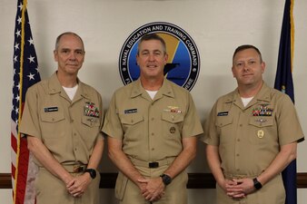 Rear Adm. Pete Garvin, center, commander, Naval Education and Training Command (NETC), Force Master Chief Rick Mengel, right, NETCs force master chief, and Force Master Chief Matthew Harris, NETC’s off-going force master chief, pose for a photograph after a change of charge ceremony at NETC headquarters onboard Naval Air Station Pensacola, February 16, 2023. NETC’s mission is to recruit, train and deliver those who serve our nation, taking them from street-to-fleet by transforming civilians into highly skilled, operational and combat ready warfighters. (United States Navy photo by Lt. j.g. Sean Panish)