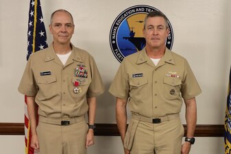 Rear Adm. Pete Garvin, right, commander, Naval Education and Training Command (NETC), poses for a photograph with Force Master Chief Matthew Harris, before a change of charge ceremony at NETC headquarters onboard Naval Air Station Pensacola, February 16, 2023. NETC’s mission is to recruit, train and deliver those who serve our nation, taking them from street-to-fleet by transforming civilians into highly skilled, operational and combat ready warfighters. (United States Navy photo by Lt. j.g. Sean Panish)