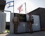 U.S. Marines with 3rd Air Naval Gunfire Liaison Company, U.S. Marine Corps Forces Reserve, hang up their unit flag during exercise Intrepid Maven 23.2, Feb. 19, 2023. Intrepid Maven is a bilateral exercise between USMARCENT and the IDF designed to improve interoperability, strengthen partner-nation relationships in the U.S. Central Command area of operations and improve both individual and bilateral unit readiness. (U.S. Marine Corps photo by Cpl. Kolby Leger)