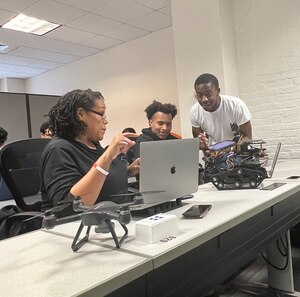 From left: Mary Nwosu, Earl Tankard Jr. and Joed Ngangmeni work on a small-scale drone and tanker for implementing asynchronous federated learning for collaboration between platforms research Feb. 17, 2023, at the Department of Defense Center of Excellence for artificial intelligence and Machine Learning, or CoE-AIML, at Howard University, Washington, D.C. The DOD announced its selection of Howard University for the science research partnership as part of the 15th University Affiliated Research Center, or UARC. Howard is the first Historically Black College or University to lead a UARC, named Research Institute for Tactical Autonomy, or RITA. (Howard University photo / Dr. Desta Hagos)