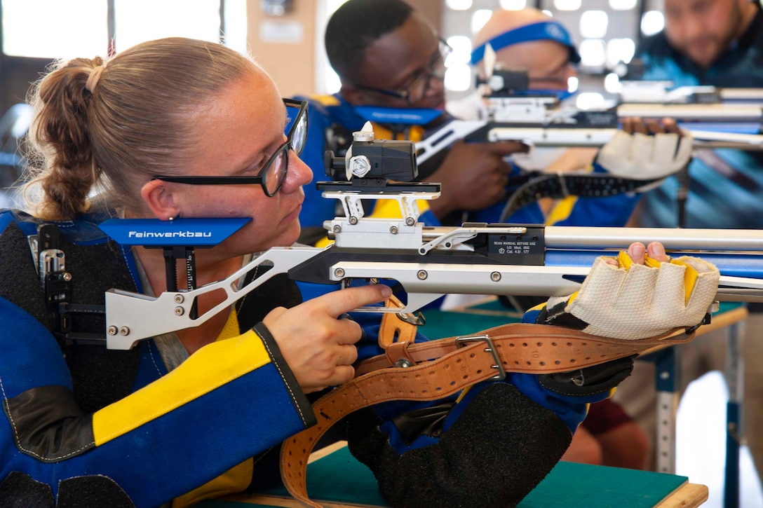 Sailors aim rifles at targets.