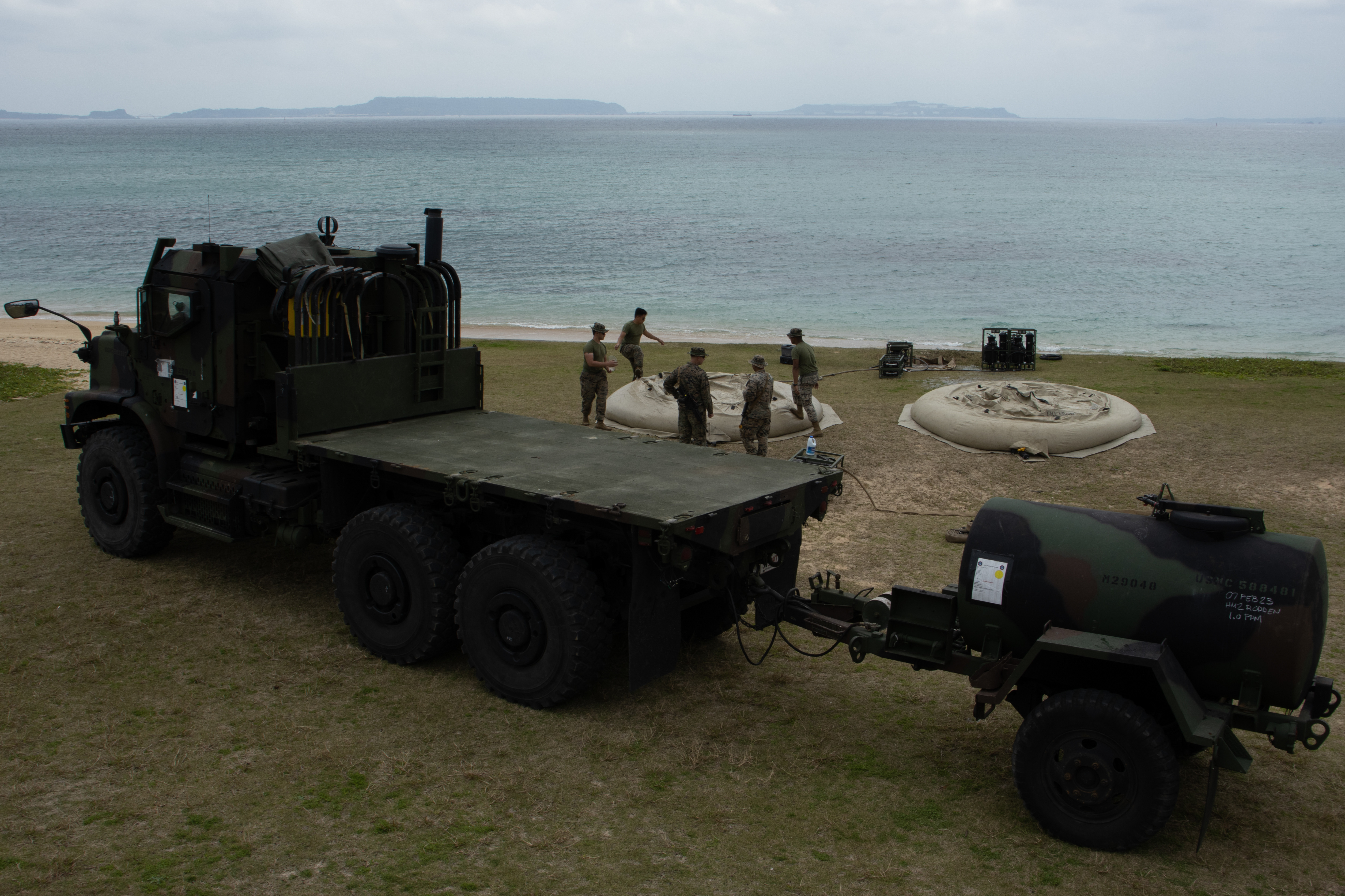 U.S. Marines with Combat Logistics Battalion 31, 31st Marine Expeditionary Unit, arrive to a water purification site during a combat service support area exercise at Kin Blue, Okinawa, Japan, Feb. 9, 2023. A CSSA provides Marines on the ground with food, water, and fuel to support the mission and sustain an area of operations. The 31st MEU is operating aboard ships of USS America Amphibious Ready Group in the 7th fleet area of operations to enhance interoperability with allies and partners and serve as a ready response force to defend peace and stability in the Indo-Pacific region. (U.S. Marine Corps photo by Cpl. Christopher R. Lape)