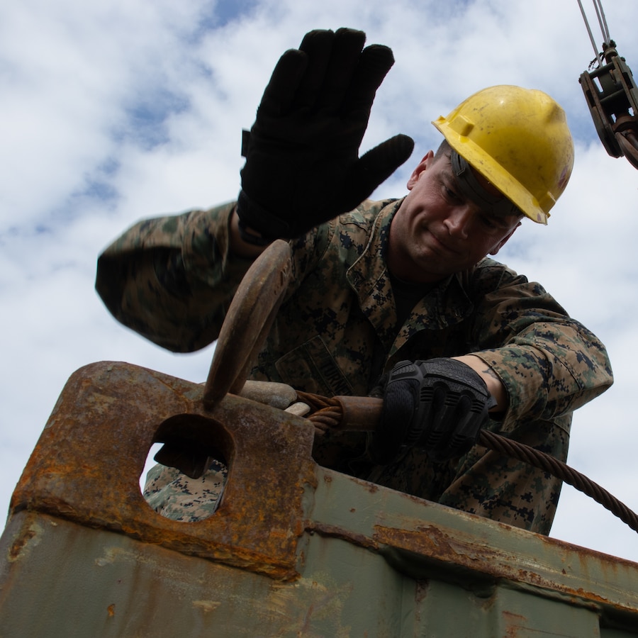 U.S. Marine Corps Cpl. Dalton Turner, a machinist with Combat Logistics Battalion 31, 31st Marine Expeditionary Unit, secures a quadcon during a combat service support area exercise at Kin Blue, Okinawa, Japan, Feb. 9, 2023. A CSSA provides Marines on the ground with food, water, and fuel to support the mission and sustain an area of operations. The 31st MEU is operating aboard ships of USS America Amphibious Ready Group in the 7th fleet area of operations to enhance interoperability with allies and partners and serve as a ready response force to defend peace and stability in the Indo-Pacific region. (U.S. Marine Corps photo by Cpl. Christopher R. Lape)