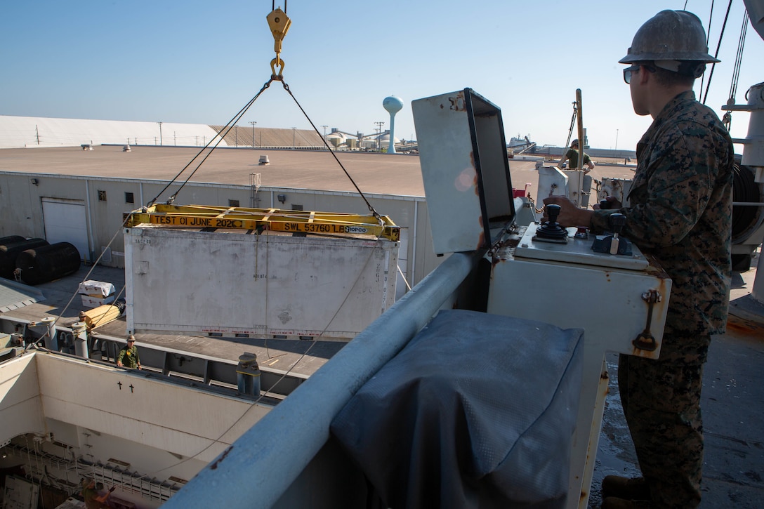 U.S. Marine Corps Cpl. Omar Villegas, an aircraft electrical/instrument/flight control systems technician with Marine Aviation Logistics Squadron (MALS) 31, controls a crane to remove avionics equipment off the Military Sealift Command aviation-logistics support ship SS Wright (T-AVB 3) at the Port of Morehead City, North Carolina, Sept. 20, 2022. The Military Sealift Command aviation-logistics support ship SS Wright (T-AVB 3) provides U.S. Marines the capability to conduct intermediate aviation maintenance aboard the ship, which reduces the time required for maintenance during a deployment.  MALS-31 is a subordinate unit of 2nd Marine Aircraft Wing, the aviation combat element of II Marine Expeditionary Force. (U.S. Marine Corps photo by Sgt. Servante R. Coba)