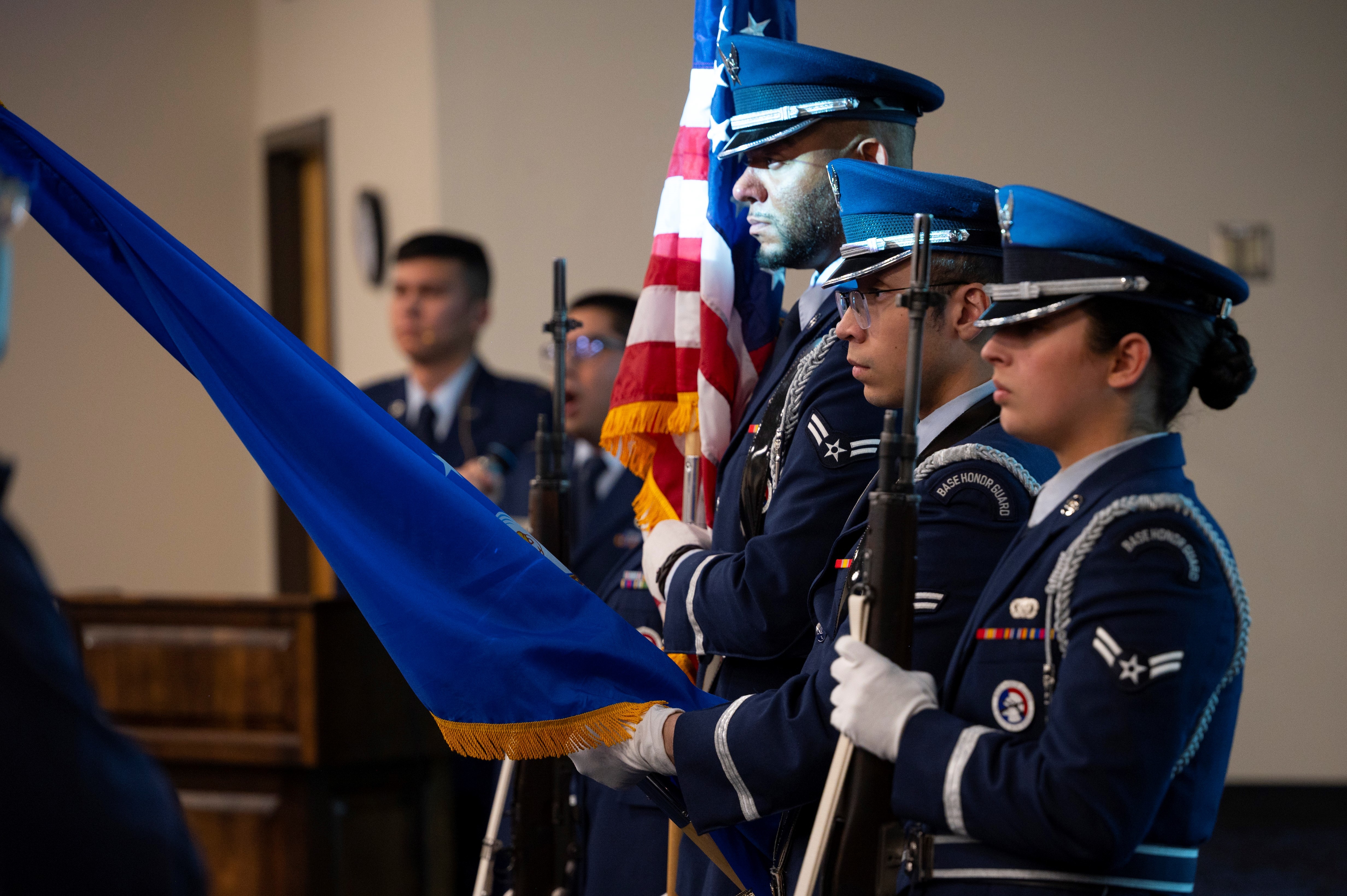 The Team Kirtland Honor Guard color guard members present the flag during the singing of the national anthem at the Air Force Research Laboratory Directed Energy Directorate 2022 annual awards ceremony Feb. 9, 2023, held at Kirtland Air Force Base, New Mexico.