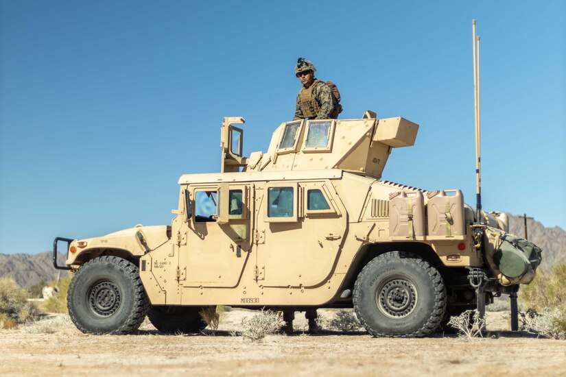 A Marine prepares to operate a vehicle.