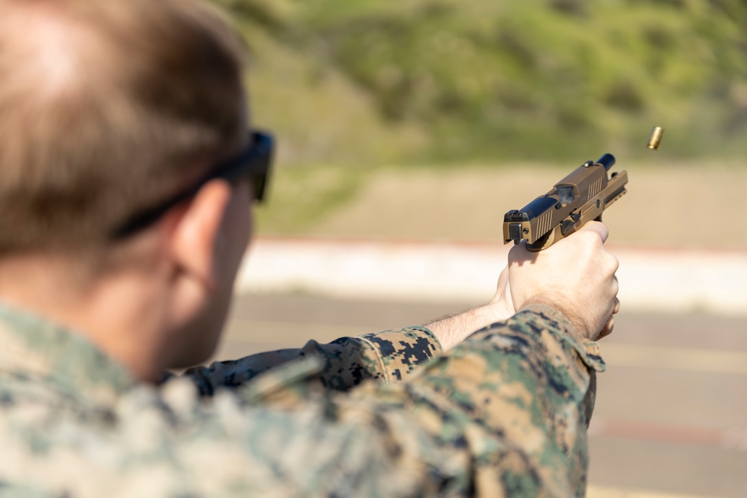 U.S. Marine Corps Sgt. Mowry, a fire support Marine with 1st Air Naval Gunfire Liaison Company, I Marine Expeditionary Force Information Group, fires an M18 service pistol during a pistol qualification range on Marine Corps Base Camp Pendleton, California, Feb. 13, 2023. Pistol qualification enables Marines to enhance their shooting skills and maintain proficiency with a side arm. (U.S. Marine Corps photo by Lance Cpl. Velasco)