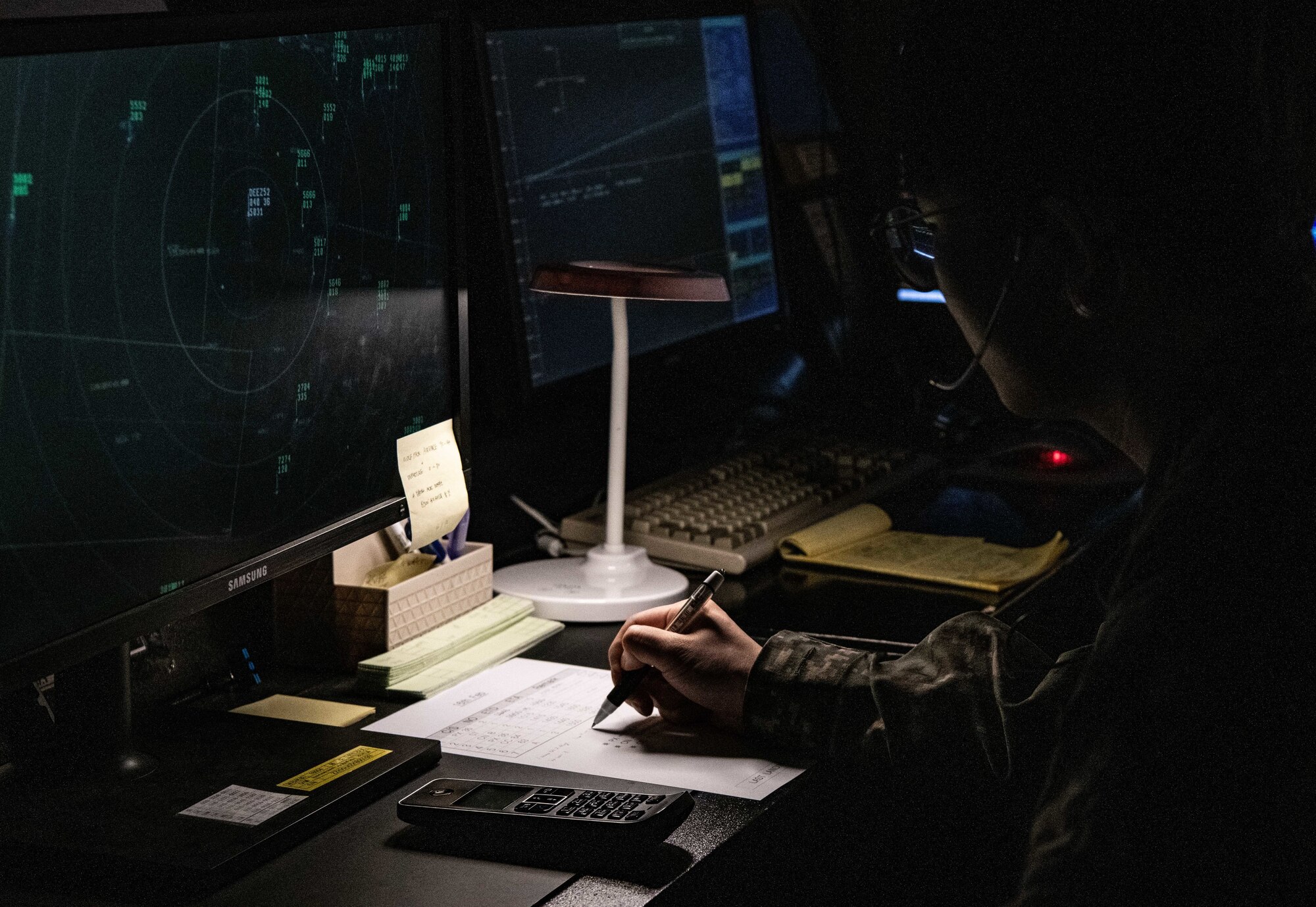 Republic of Korea Air Force Master Sgt. Seong Jin Kim, 38th Fighter Group operating branch radar controller, looks at a radar at Kunsan Air Base, Republic of Korea, Feb. 16, 2023. The ROKAF RAPCON personnel worked hand-in-hand with the U.S. Air Force air traffic control RAPCON members to maintain oversight of the Wolf Pack’s airspace. (U.S. Air Force photo by Staff Sgt. Sadie Colbert)