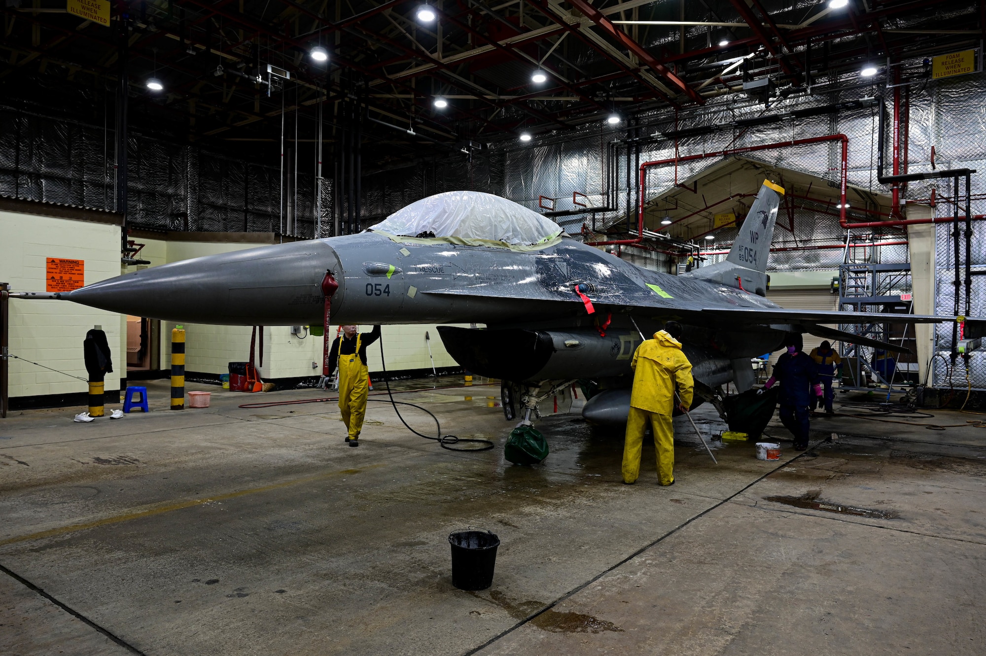 Members of the 8th Maintenance Squadron corrosion control section, wash an F-16 Fighting Falcon at Kunsan Air Base, Republic of Korea, Feb. 17, 2023.