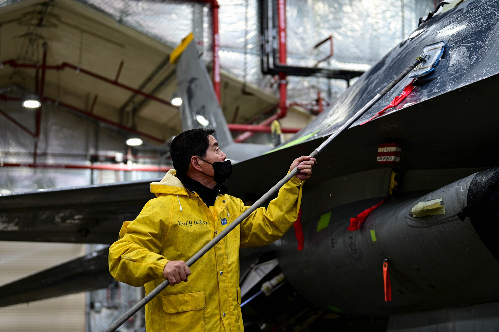 Huan Dok Chang, 8th Maintenance Squadron corrosion control section aircraft painter, scrubs an F-16 Fighting Falcon at Kunsan Air Base, Republic of Korea, Feb. 17, 2023.