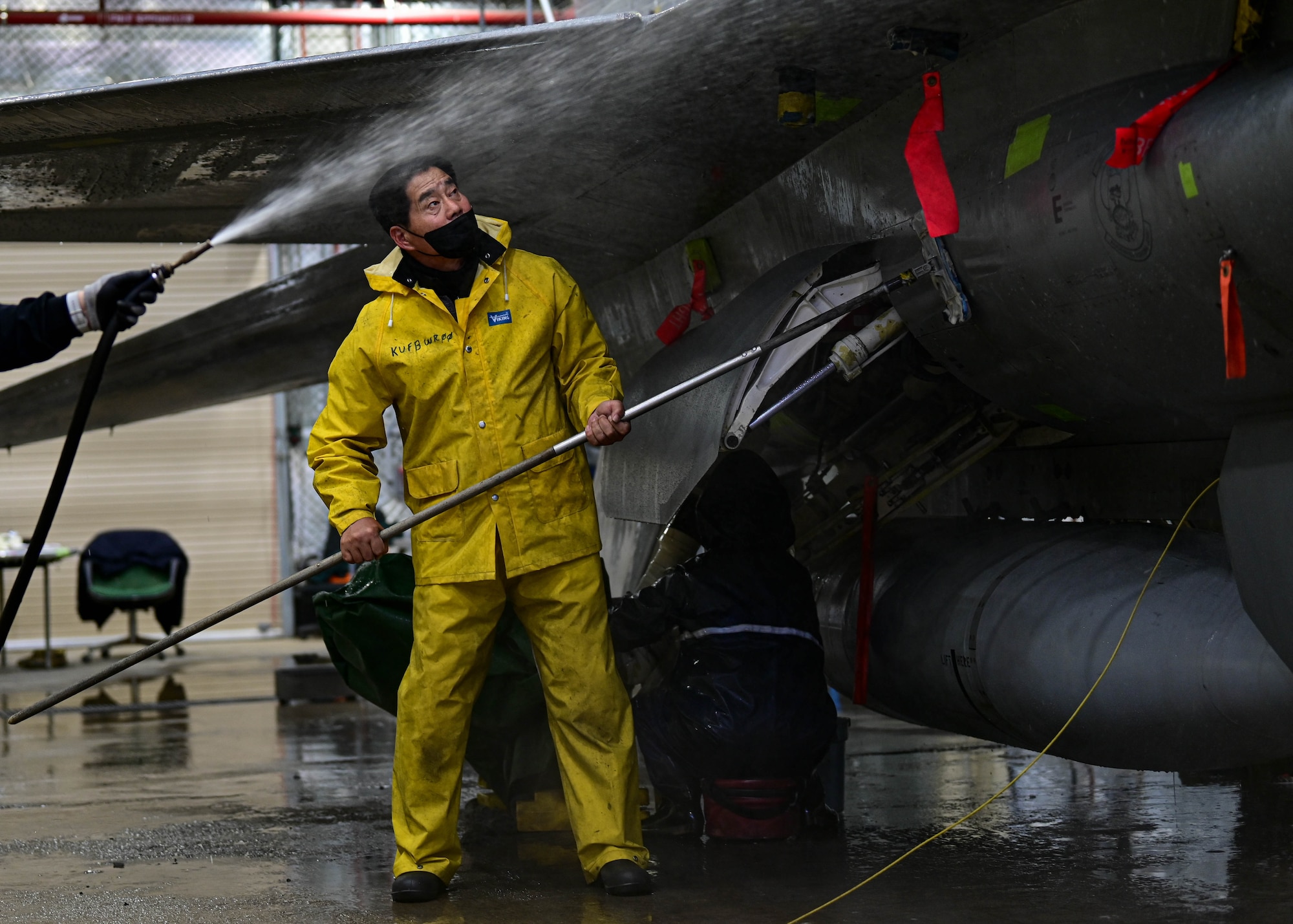 Huan Dok Chang, 8th Maintenance Squadron corrosion control section aircraft painter, scrubs an F-16 Fighting Falcon at Kunsan Air Base, Republic of Korea, Feb. 17, 2023.