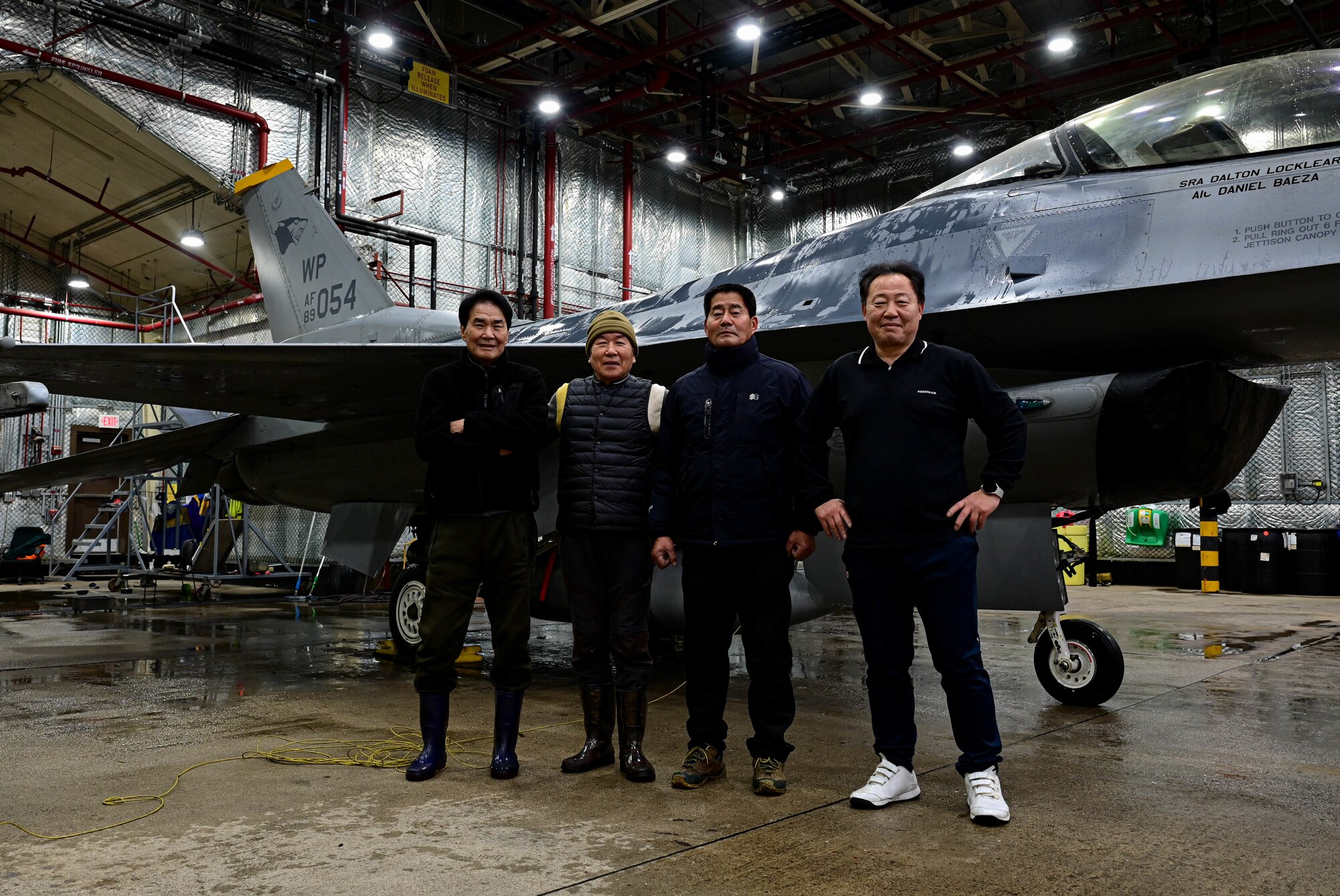 Members of the 8th Maintenance Squadron corrosion control section, pose for a photo in front of an F-16 Fighting Falcon at Kunsan Air Base, Republic of Korea, Feb. 17, 2023