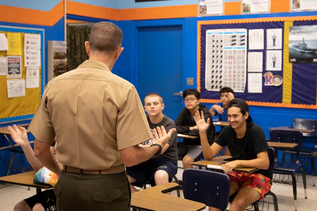 U.S. Marine Corps Lt. Col. Caleb Eames from Marine Corps Base Hawaii, speaks to students at Kalaheo High School about opportunities the Marine Corps offers during career day, Kailua, Hawaii, Feb. 10, 2023. Marine Corps Recruiters based on Oahu attended career day to enhance recruiting efforts and to build stronger relationships with the community. (U.S. Marine Corps photo by Lance Cpl. Terry Stennett III)