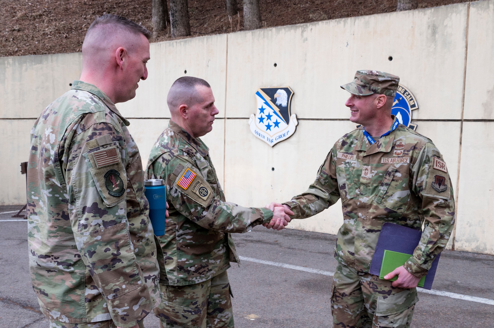 ommand Sgt. Maj. Jack Love, U.S. Forces Korea Senior Enlisted Advisor shakes hands with Chief Master Sgt. Matthew Phillips, 694th Intelligence, Surveillance and Reconnaissance Group (ISRG) senior enlisted leader, during his visit at Osan Air Base, Republic of Korea, Feb. 16, 2023.