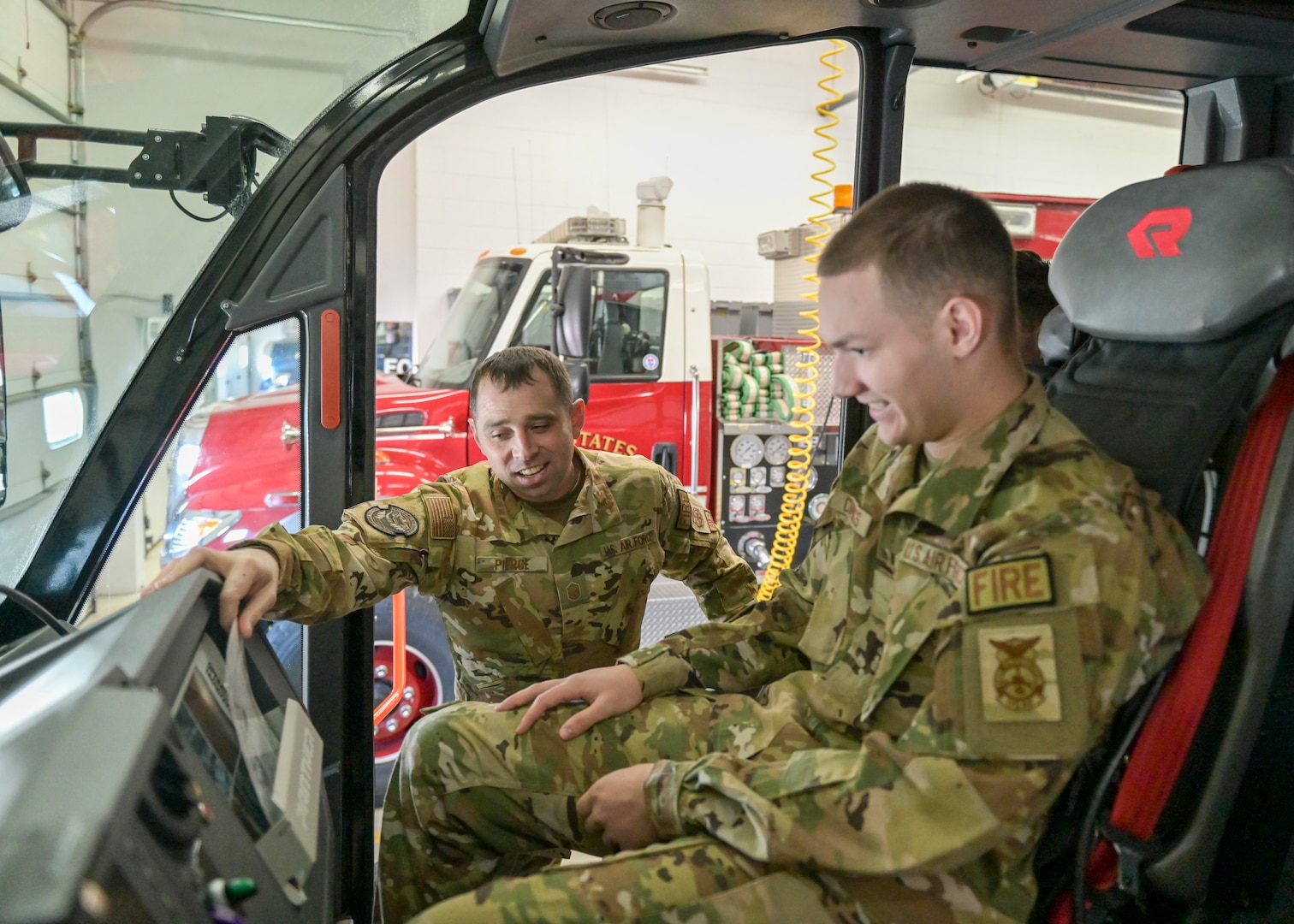 U.S. Air Force Master Sgt. Colin Pierce, the assistant fire chief of training at the 115th Fire and Emergency Services flight, Truax Field, Madison, Wisconsin trains Airman Basic Kody Cummings, a a fire prevention specialist with the 115th, on the functions of an aircraft rescue fire fighting truck Feb. 2, 2023. Pierce was recently named the 2022 Air National Guard Military Fire Officer of the Year. (U.S. Air National Guard photo by Staff Sgt. Cameron Lewis)