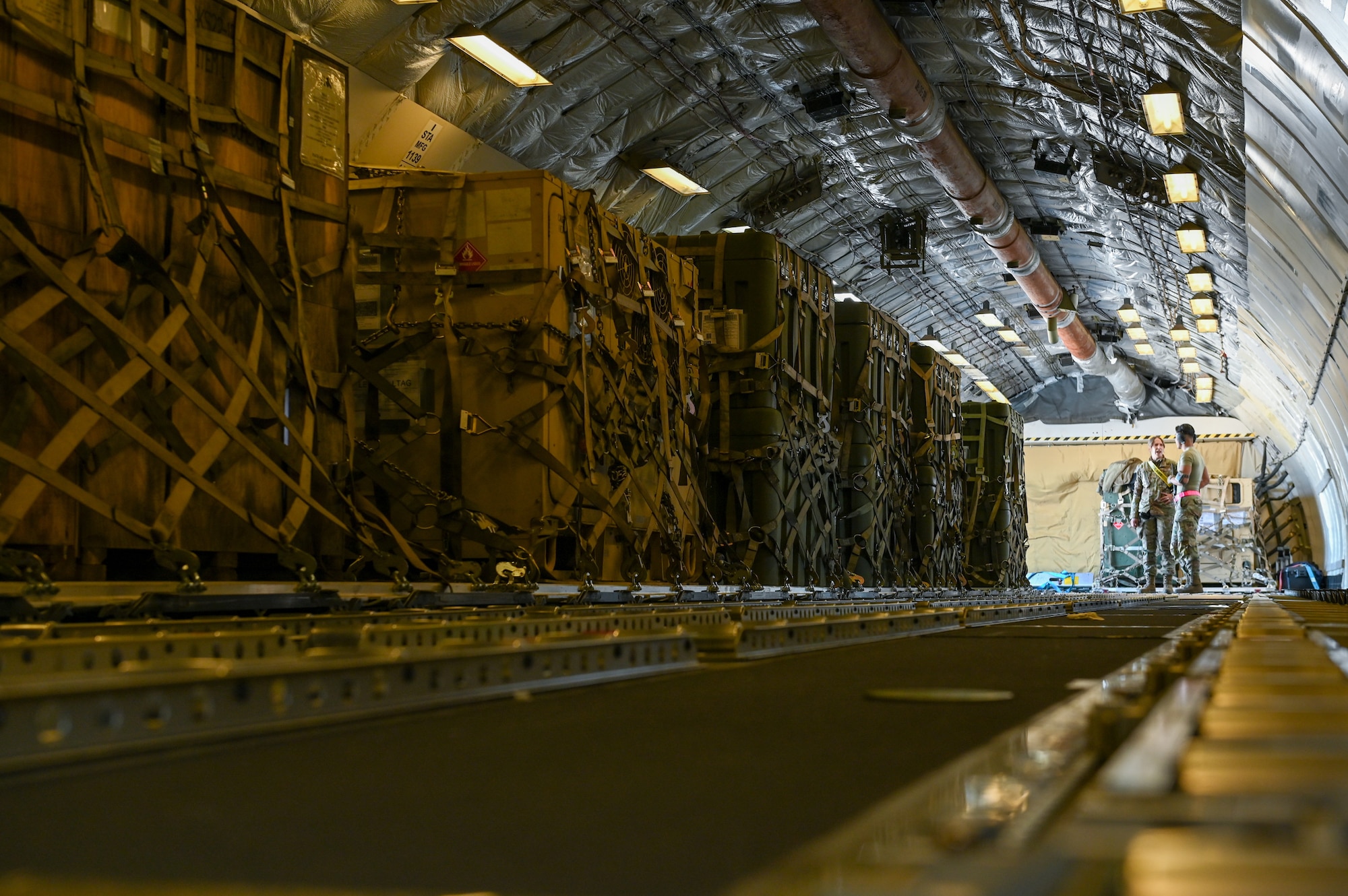 Airman 1st Class Kaylan Bartlett, left, an aircraft services technician assigned to the 728th Air Mobility Squadron, and Staff Sgt. Jason Dumag, a ramp controller assigned to the 728th AMS, waits to unload medical shelters and equipment at Incirlik Air Base, Türkiye, Feb. 18, 2023.