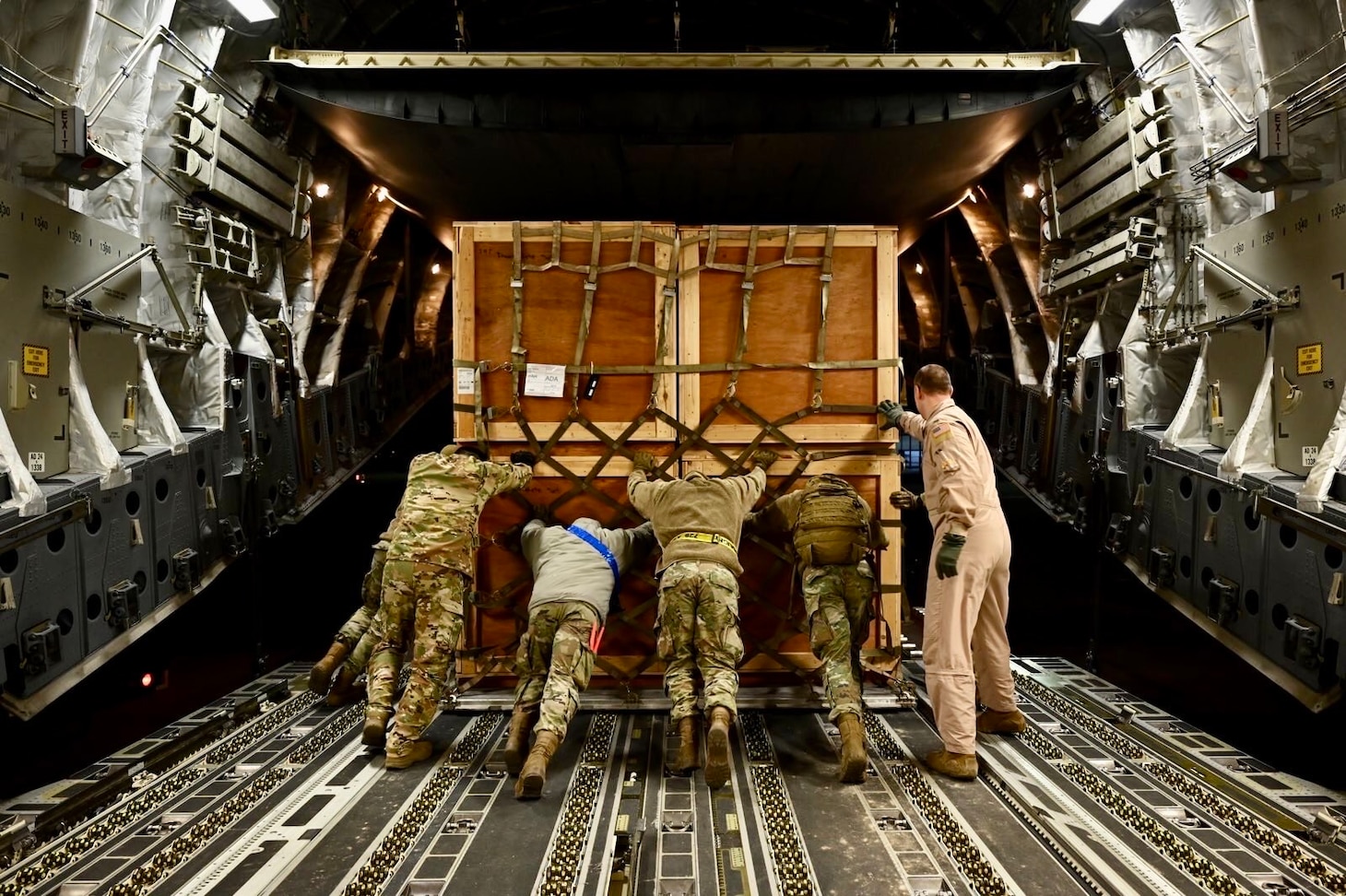 U.S. Air Force Airmen unload humanitarian aid supplies from a C-17 Globemaster III assigned to the 8 th Expeditionary Airlift Squadron, to provide international aid to Turkey at Incirlik Air Base, Turkey, Feb. 21, 2023. The 8 th EAS personnel airlifted 18 pallets containing tents and emergency supplies, providing humanitarian assistance in response to the devastating impacts in Turkey following the worst earthquake to hit the region in almost a century. (U.S. Air Force photo by Staff Sgt. Gerald R. Willis)