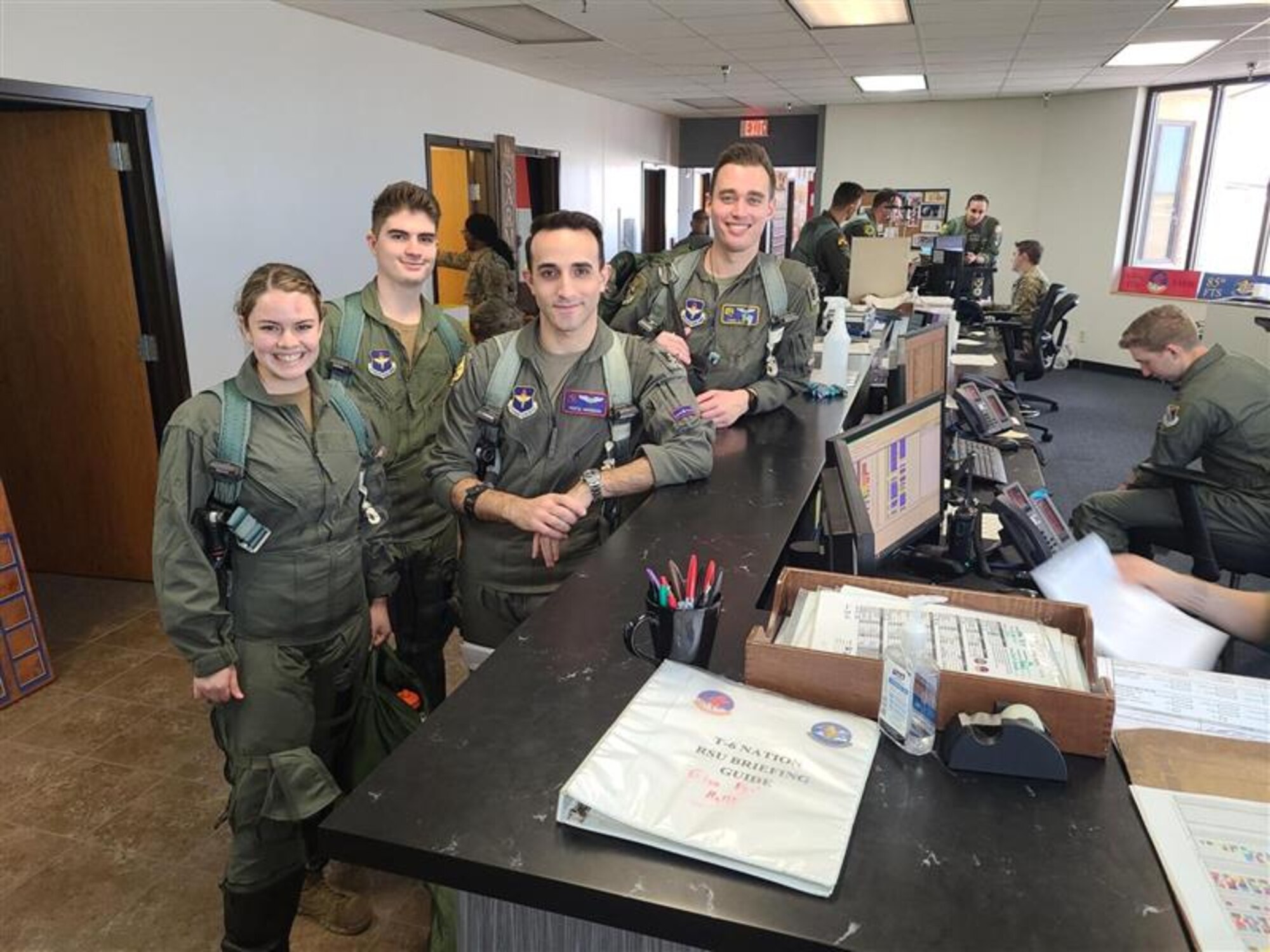 U.S. Air Force pilots and Texas A&M College Air Force Reserve Officer Training Corps
(AFROTC) members pose for a photo at the T-6 Texan II step desk at Laughlin Air Force Base,
Texas, on Jan. 12, 2023.