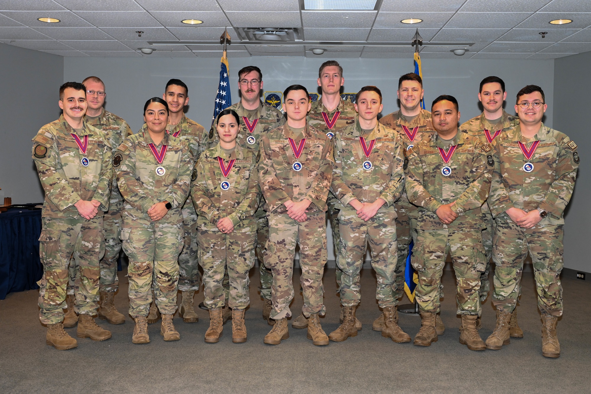 A group of people in uniform stand on a stage