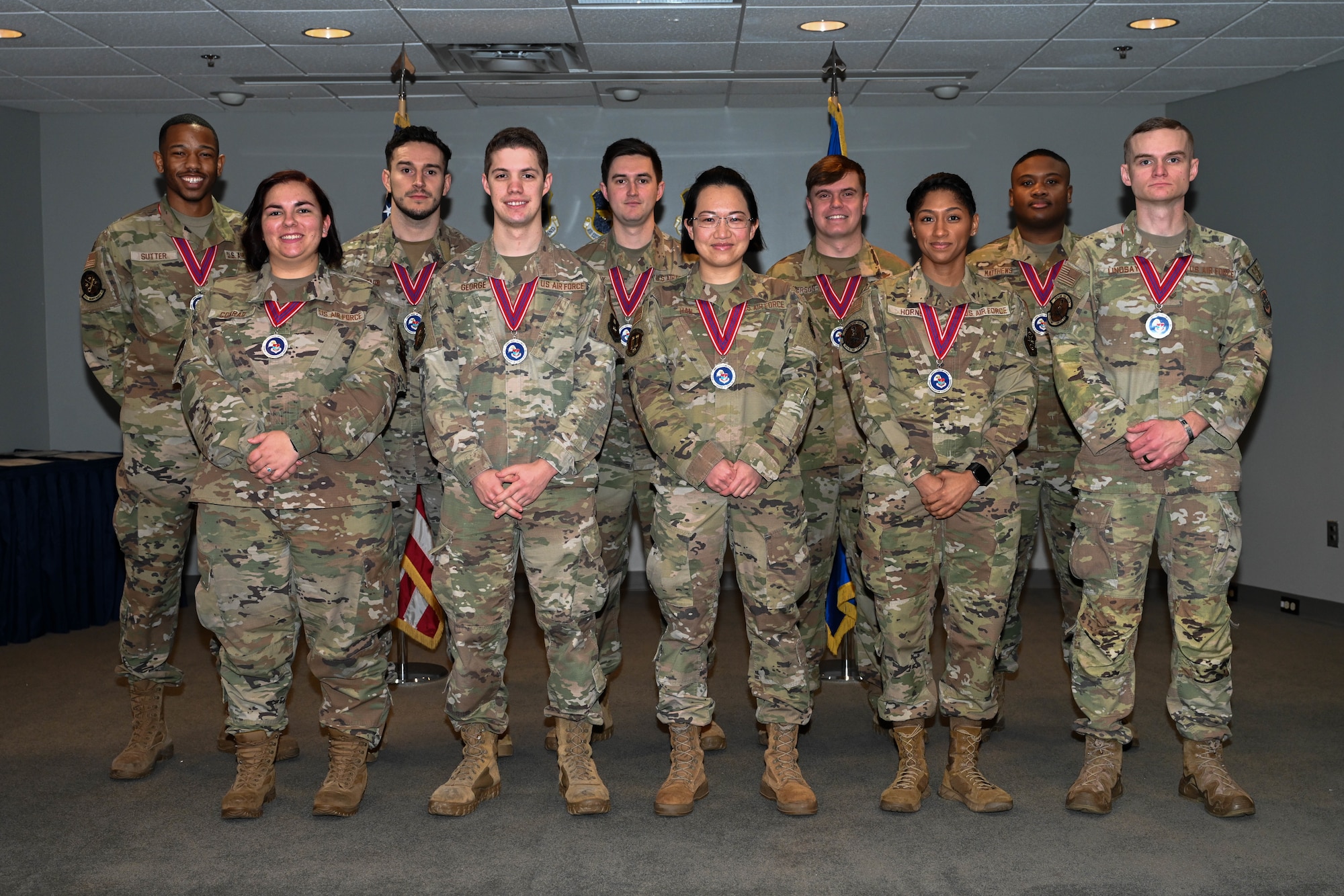 A group of people in uniform stand on a stage