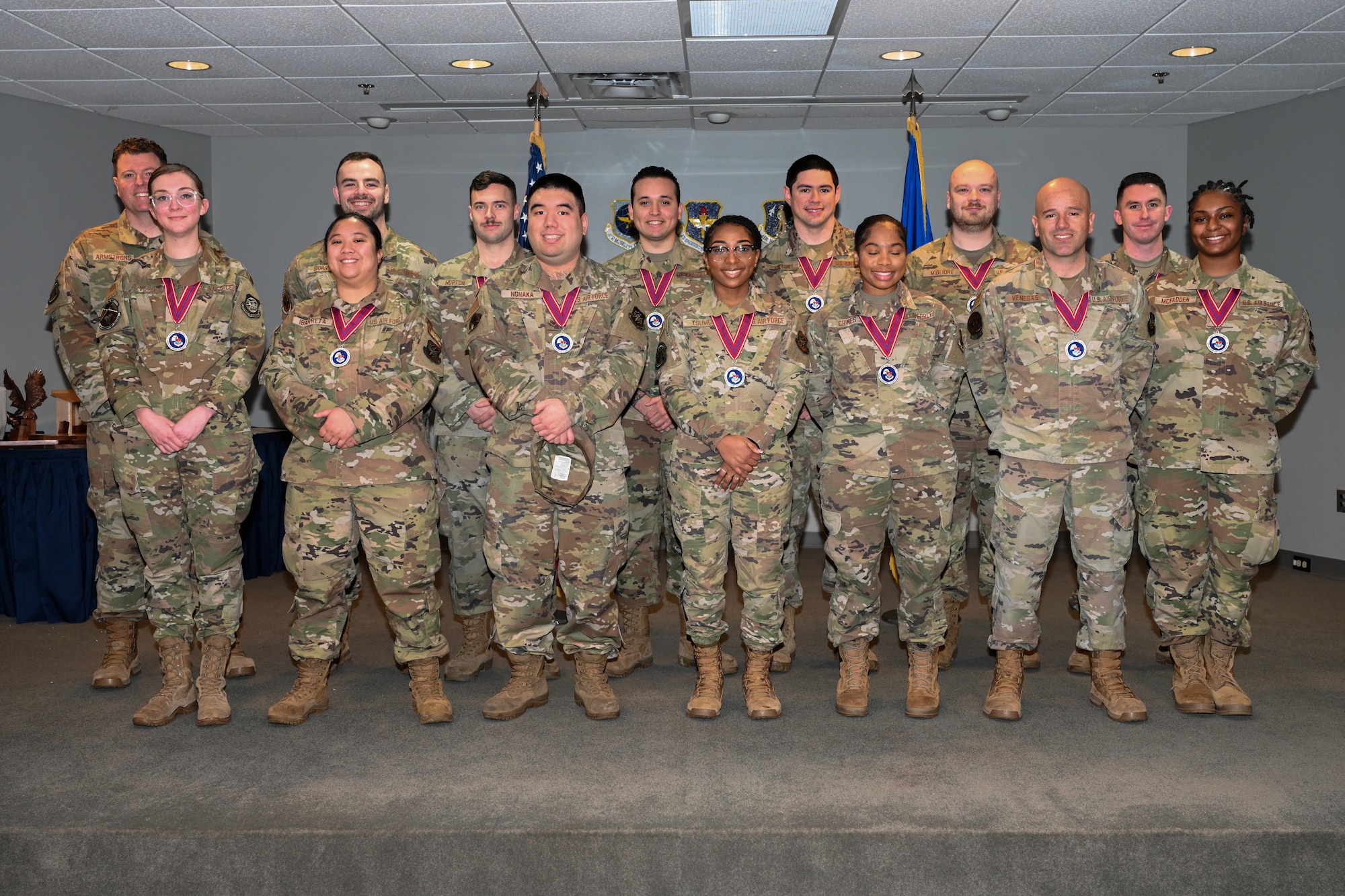 A group of people in uniform stand on a stage