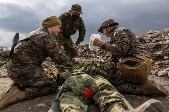 Corpsmen treat a simulated casualty during a mass casualty exercise in Hijudai, Japan.