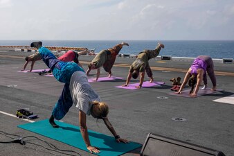Sailors attend a yoga class aboard USS Makin Island (LHD 8) in the South China Sea.