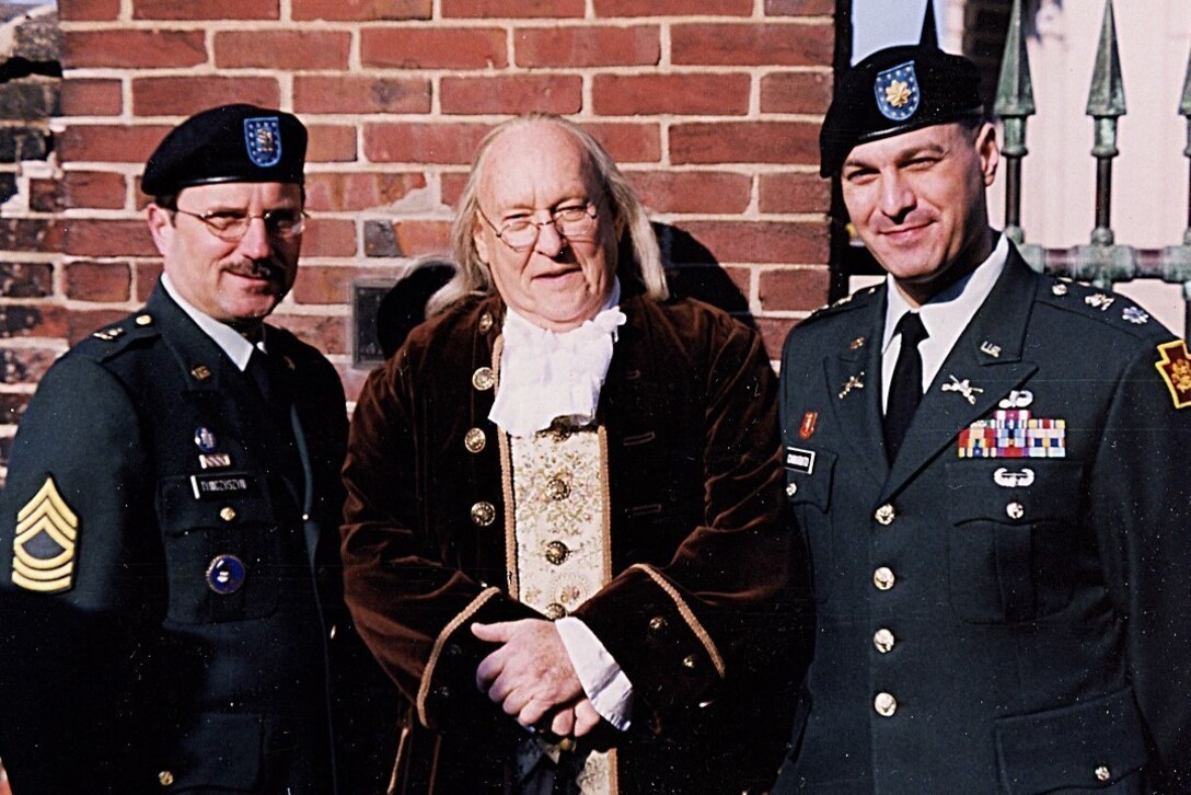 Then-Master Sgt. Roman Tymczyszyn poses with a Benjamin Franklin reenactor and his recruiting area commander Maj. Thomas Cannariato in 2004 during the yearly graveside ceremony honoring Franklin for his many accomplishments, including founding the organization in 1747 that would eventually become the Pennsylvania National Guard. Tymczyszyn served in the Pennsylvania National Guard for 35 years, and for the last 18 years he has worked as a civilian contractor for recruiting. (Photo courtesy of Roman Tymczyszyn)