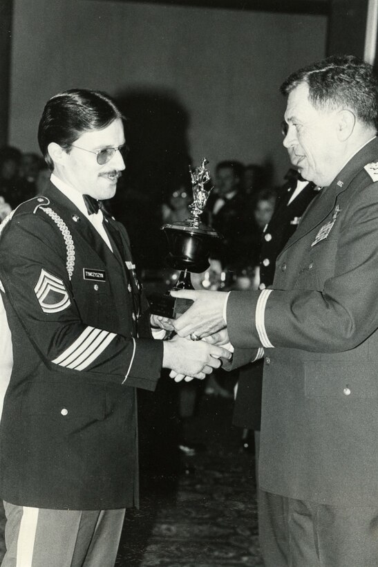 Then-Sgt. 1st Class Roman Tymczyszyn, left, receives an award from then-Adjutant General Maj. Gen. Richard Scott for being the top Pennsylvania student recruiter for 1983 at a recruiting awards ceremony at Fort Indiantown Gap. Tymczyszyn served in the Pennsylvania National Guard for 35 years, and for the last 18 years he has worked as a civilian contractor for recruiting. (Photo courtesy of Roman Tymczyszyn)