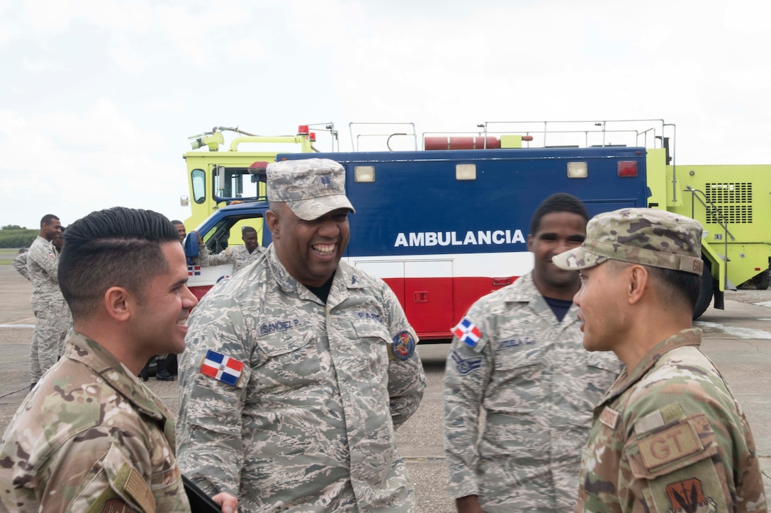 Fuerza Aérea de República Dominicana and U.S. Air Force Airmen discuss emergency response plans and capabilities at San Isidro Air Base.