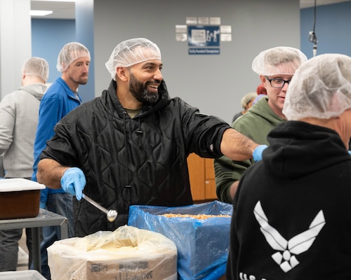 U.S. Air Force Airman 1st Class Riyadh Al-Shihmani, 934th Force Support Squadron services specialist, helps fill bags with soy and vitamins at the Feed My Starving Children facility in Eagan, Minnesota Feb. 2, 2023. The meals Al-Shihmani helped pack were planned to be sent to children and families in Colombia. (U.S. Air Force photo by Senior Airman Victoriya Tarakanova)