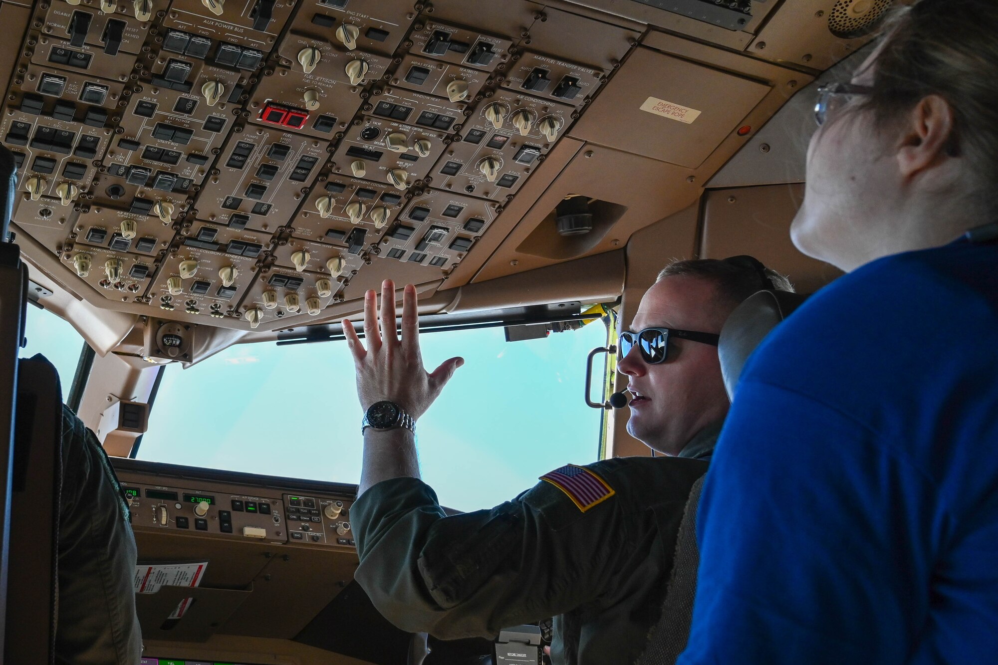 U.S. Air Force Capt. Geoffrey Holscher, 56th Air Refueling Squadron instructor pilot, explains different controls inside the cockpit of a KC-46 Pegasus to Legacy Flight Academy students at Joint Base Charleston, South Carolina, Feb. 18, 2023. Fourteen Airmen and a KC-46 Pegasus represented the 97th Air Mobility Wing from Altus Air Force Base, Oklahoma, at Accelerating the Legacy 2023. (U.S. Air Force photo by Senior Airman Trenton Jancze)