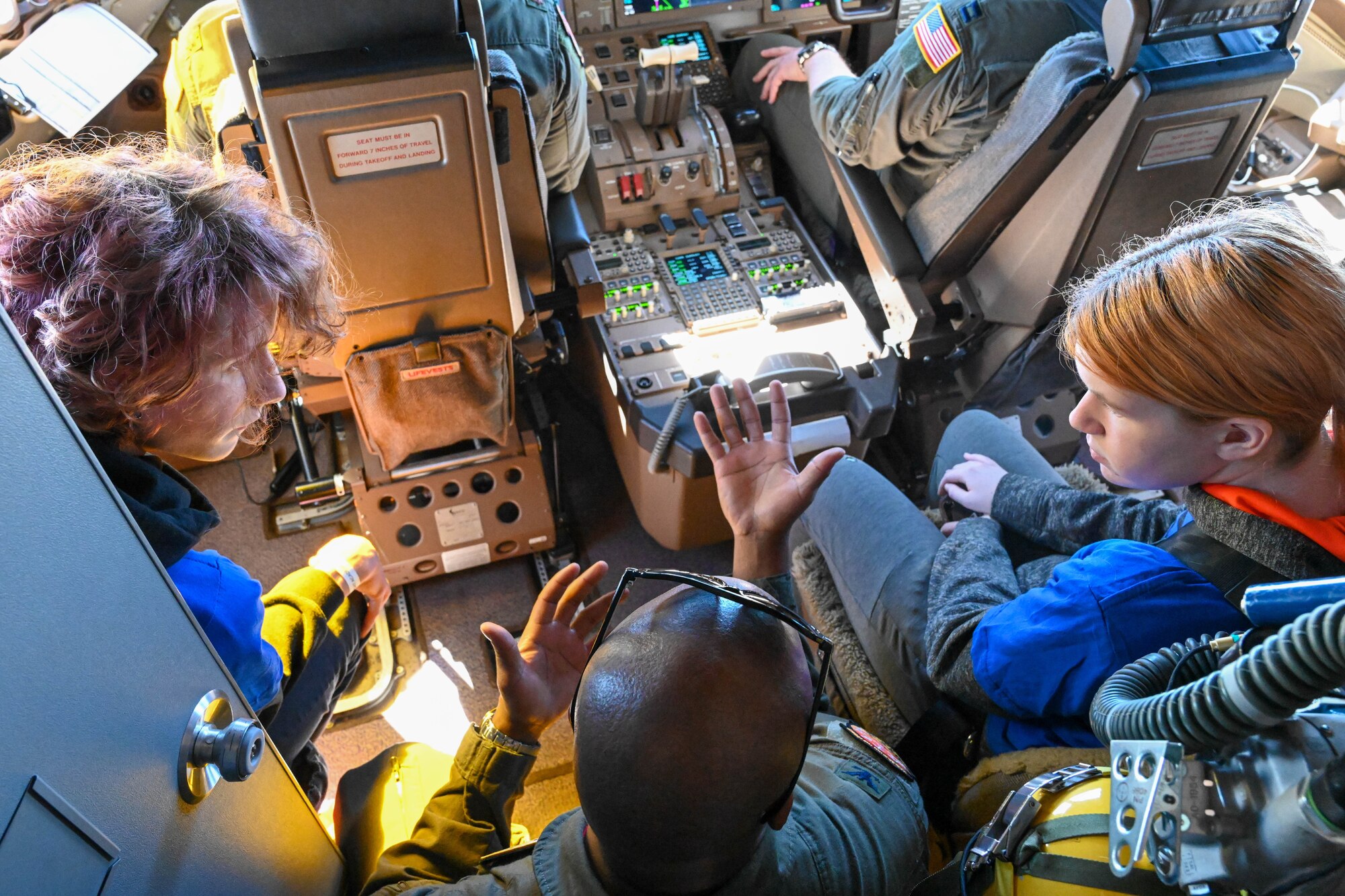 U.S. Air Force Col. Patrick Brady-Lee, 97th Air Mobility Wing vice commander, explains different controls in the cockpit of a KC-46 Pegasus to Legacy Flight Academy students during Accelerating the Legacy 2023 at Joint Base Charleston, South Carolina, Feb. 18, 2023. The Legacy Flight Academy co-hosted the third day of Accelerating the Legacy, allowing local students to interact with Airmen and learn more about aerospace-focused military careers. (U.S. Air Force photo by Senior Airman Trenton Jancze)