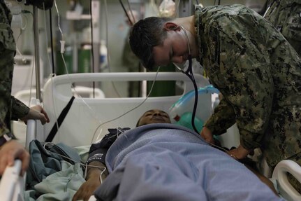 NORFOLK, Va. (Feb. 16, 2023) Wasp-class amphibious assault ship USS Bataan (LHD 5) Internal Medicine Doctor Lt. Thomas Brooke examines Hospital Corpsman 2nd Class Farrie Jalin as part of a pier-side trauma training exercise, Feb. 16, 2023. The evolution was conducted as part of a Naval Medical Forces Atlantic and U.S. Fleet Forces Command-driven effort to align with and support fleet and joint requirements, and to improve deployment readiness of organic fleet medical departments. During the evolution, the ship’s medical staff participated in several medical scenarios and received real-time feedback in order to build enhanced knowledge and skillsets. (U.S. Navy photo by Mass Communication Specialist 2nd Class Darren Newell)