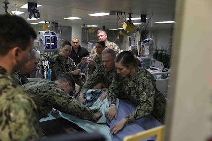 NORFOLK, Va. (Feb. 16, 2023) Wasp-class amphibious assault ship USS Bataan (LHD 5) Medical Department Sailors perform a simulated x-ray as part of a pier-side trauma training exercise, Feb. 16, 2023. The medical exercise was conducted as part of a Naval Medical Forces Atlantic and U.S. Fleet Forces Command-driven effort to align with and support fleet and joint requirements, and to improve deployment readiness of organic fleet medical departments. During the evolution, the ship’s medical staff participated in several medical scenarios and received real-time feedback in order to build enhanced knowledge and skillsets. (U.S. Navy photo by Mass Communication Specialist 2nd Class Darren Newell)