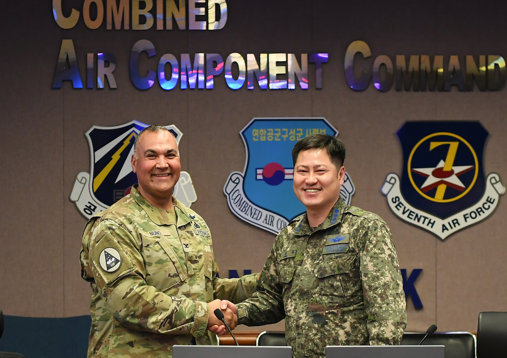 U.S. Space Force Col. George Nuno (left), International Space Cooperation Partnership Office director, shakes hands with Republic of Korea Air Force Col. Choi Sung-Hwan (right), ROKAF Headquarters Space Center director, before a meeting of the U.S. Space Policy Consultative Group Meeting Feb. 22, 2023, at Osan Air Base, Republic of Korea.