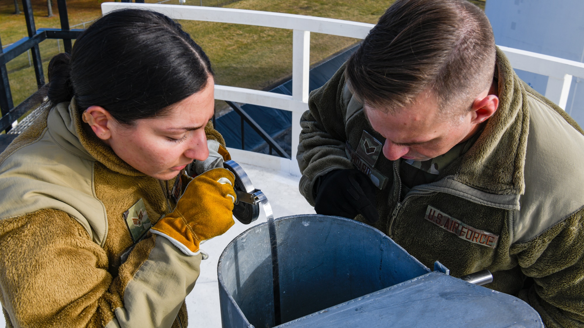 Senior Airman Victoria Russo and Senior Airman Brody Hoard, fuels specialists assigned to the 910th Logistics Readiness Squadron, measure the fluid level in one of the 910th Airlift Wing’s fuel tanks, Jan. 8, 2023, at Youngstown Air Reserve Station, Ohio.
