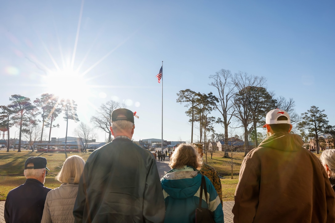 Members of American Legion Post 539 watch the 2d Marine Aircraft Wing band play during a colors ceremony at Marine Corps Air Station (MCAS) Cherry Point, North Carolina, Feb. 13, 2023. The tour allowed participants an inside look at some installation assets and the daily responsibilities of service members at Cherry Point. (U.S. Marine Corps photo by Lance Cpl. Lauralle Walker)