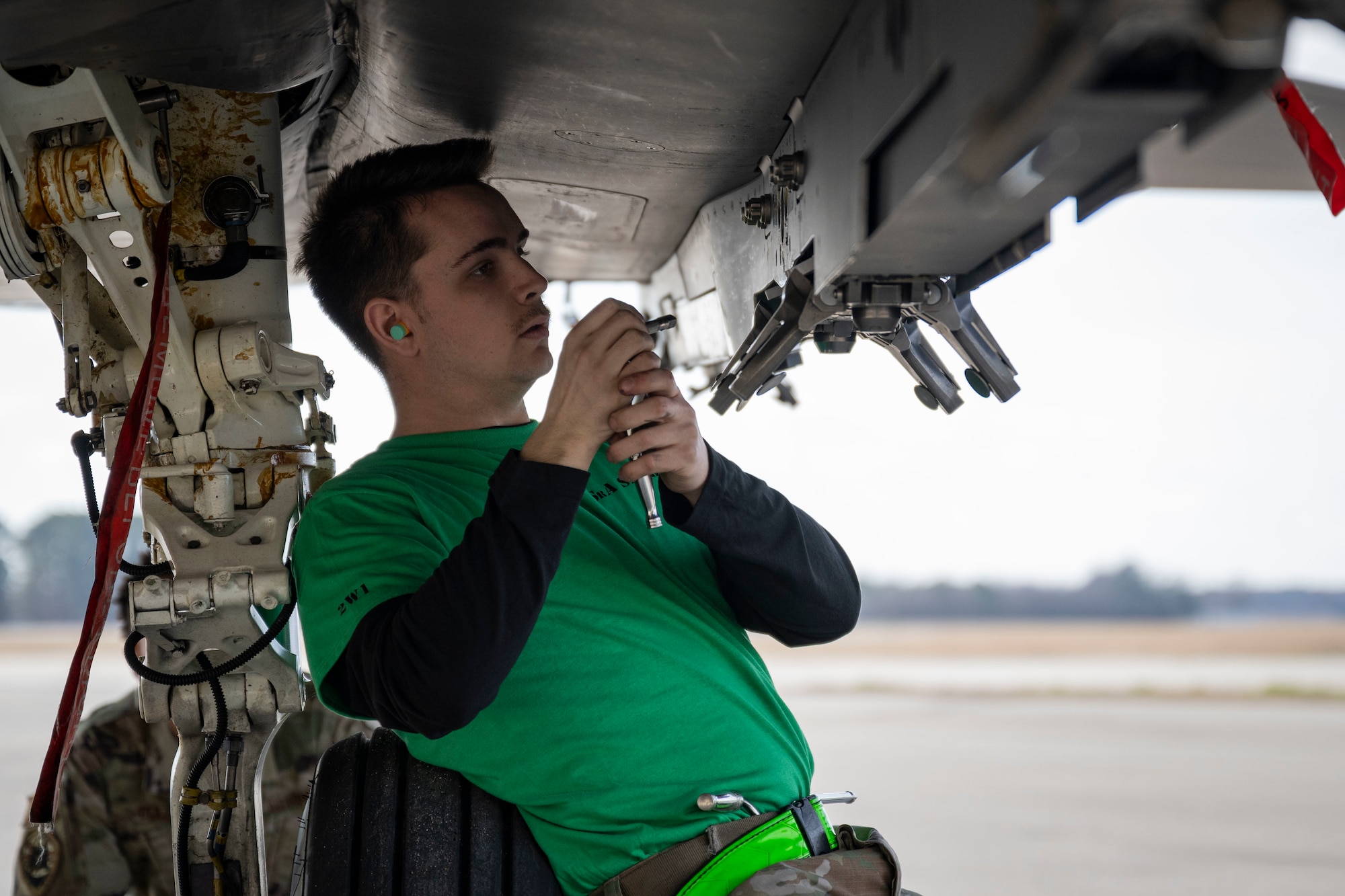 Senior Airman Mitchell Sanborn, 335th Fighter Generation Squadron weapons load crew member, prepares a bomb rack on an F-15E Strike Eagle during a weapon load crew of the year competition at Seymour Johnson Air Force Base, North Carolina, Feb. 10, 2023. Competition events include a 20-question knowledge test, weapons building and loading procedures and a composite toolkit inspection