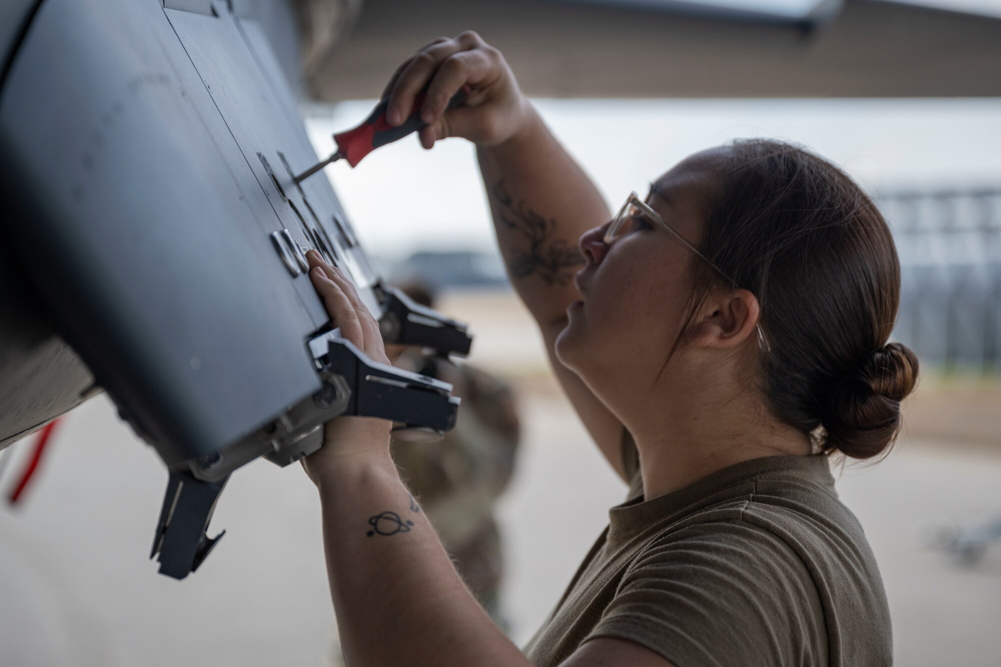 Senior Airman Savannah Hogge, 336th Fighter Generation Squadron weapons load crew member, tightens a screw on an F-15E Strike Eagle during a weapon load crew of the year competition at Seymour Johnson Air Force Base, North Carolina, Feb. 10, 2023. Load crew competitions prepare airmen for fast paced operations they may experience while deployed.