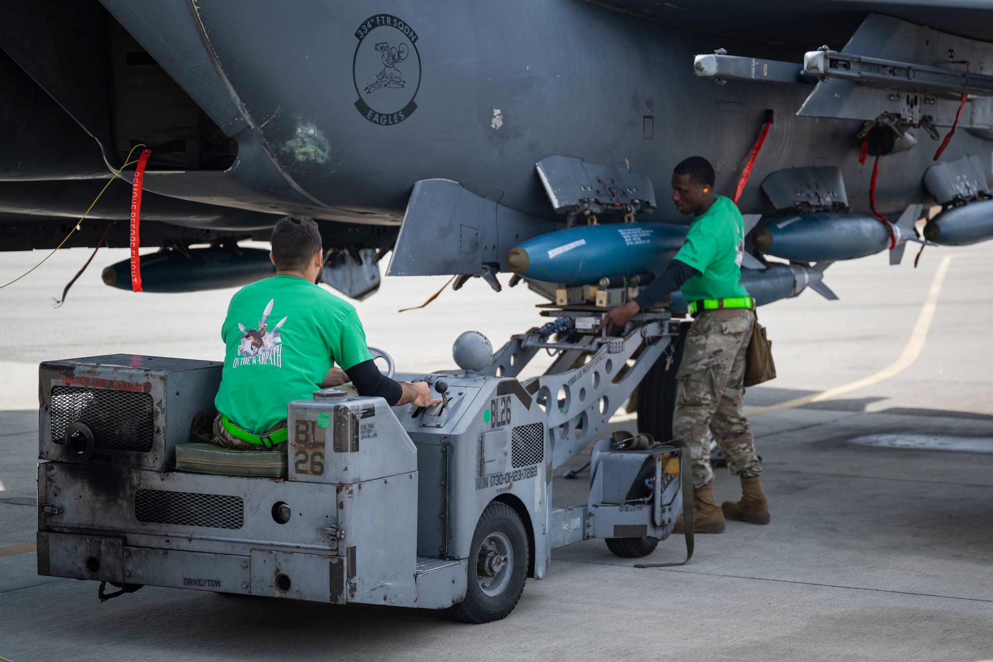 Senior Airman Mitchell Sandborn, 335th Fighter Generation Squadron weapons load crew team member, left, and Staff Sgt. Jashaunn Jasper, 335th FGS weapons load crew team chief, load a weapon onto an F-15E Strike Eagle during a weapons load crew of the year competition at Seymour Johnson Air Force Base, North Carolina, Feb. 10, 2023. The competition focuses on team’s accuracy, safety and efficiency