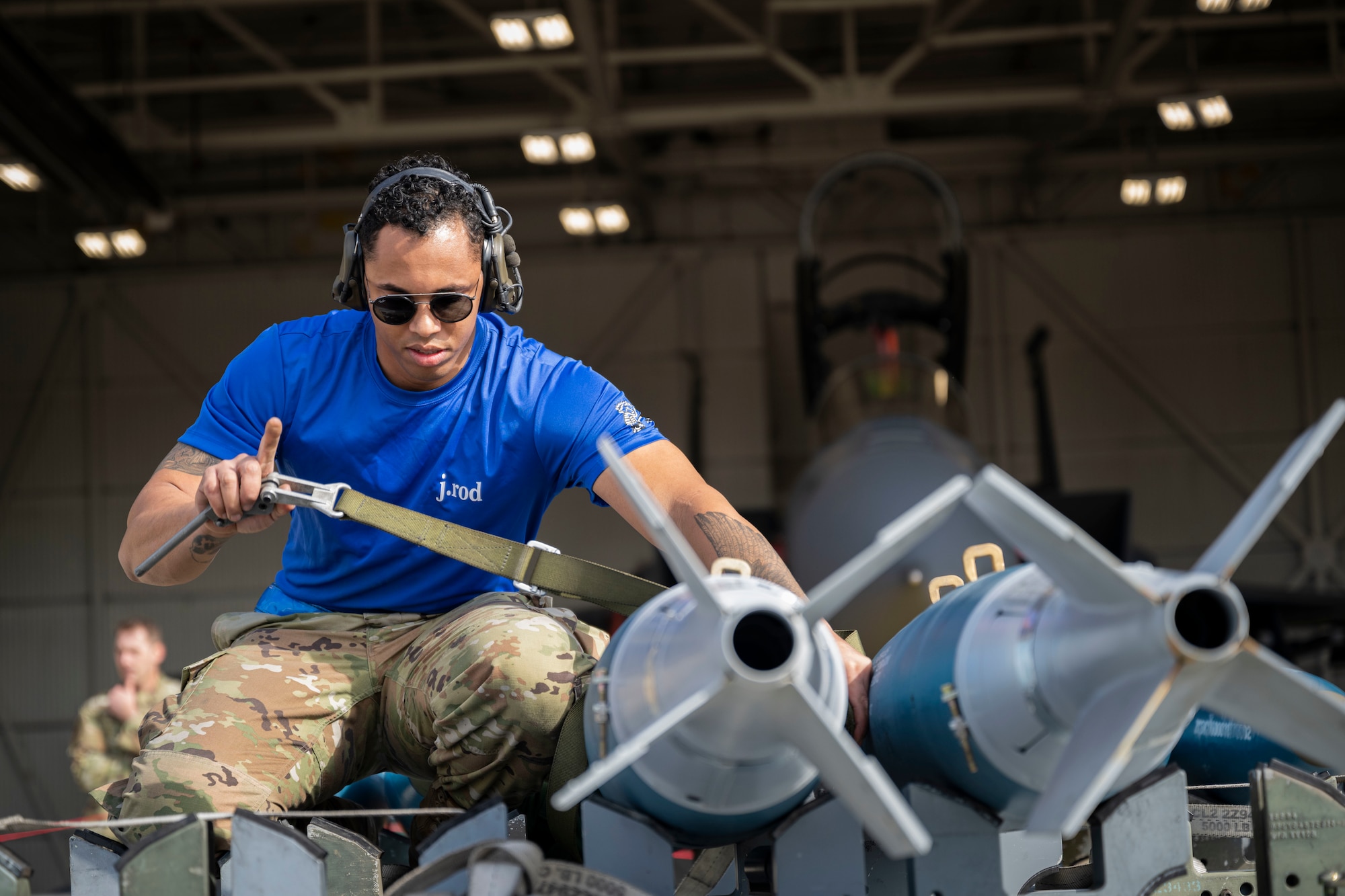 Staff Sgt. Jovany Rodriguez, 334th Fighter Generation Squadron weapons load crew team chief, unstraps a weapon during a weapons load crew of the year competition at Seymour Johnson Air Force Base, North Carolina, Feb. 10, 2023. Competition events include a 20-question knowledge test, weapons building and loading procedures and a composite toolkit inspection.