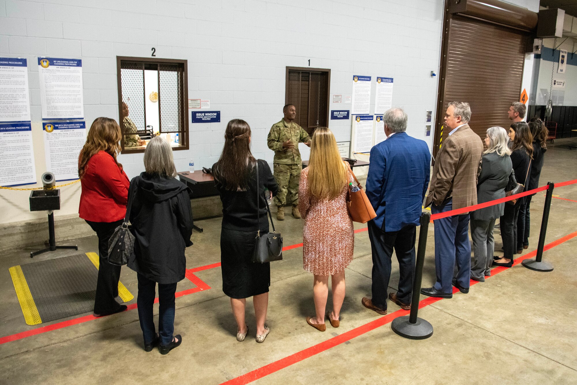 Military members brief a group of civic leaders inside the passenger terminal.
