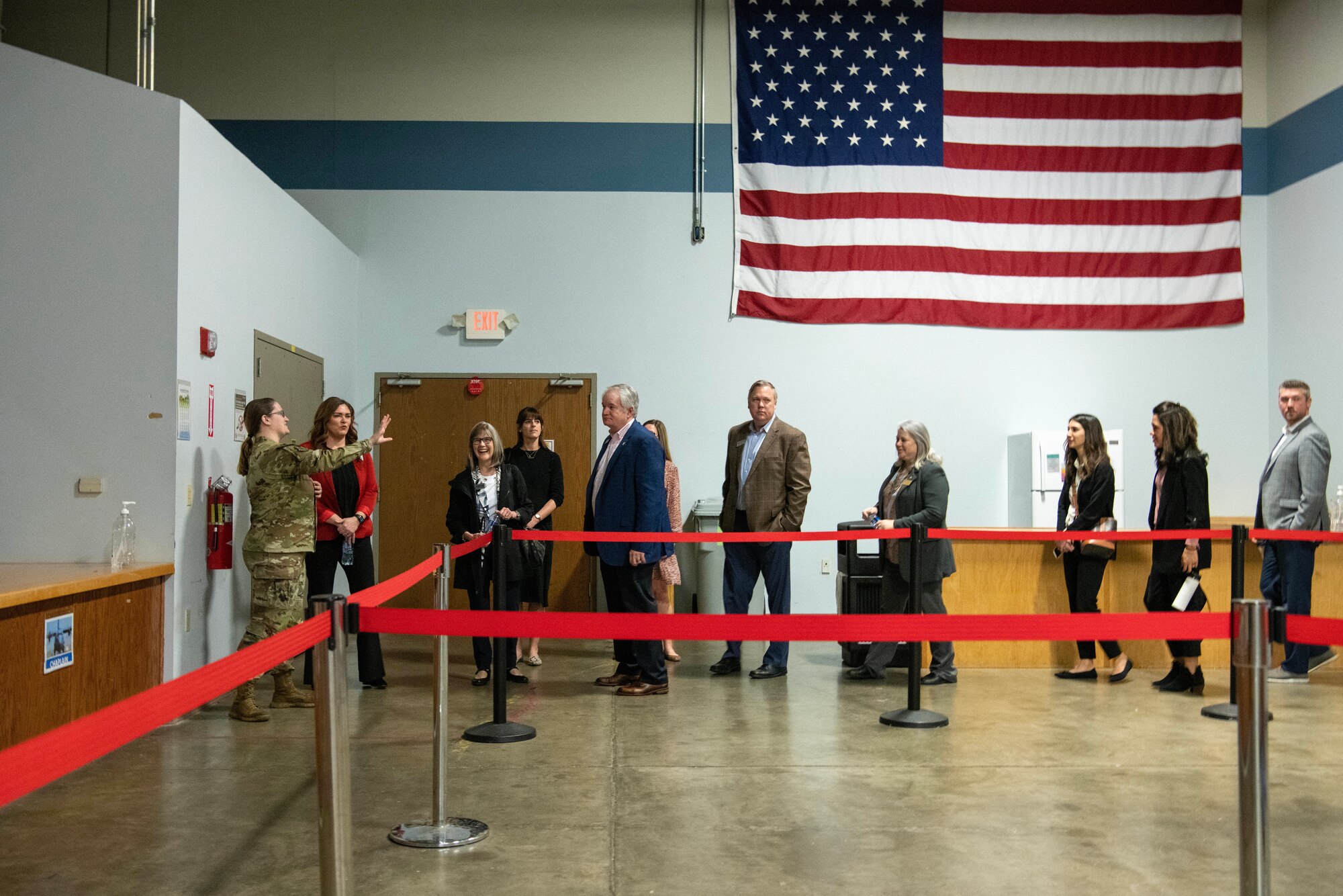 People receive an overview of the passenger terminal with an American flag displayed on the wall.