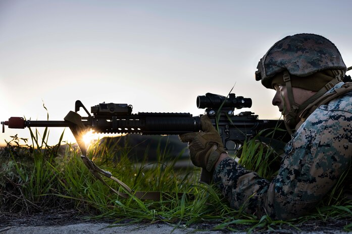 U.S. Marine Corps Sgt. Christian Asher, a heavy equipment operator with Marine Wing Support Squadron 373, Marine Air Control Group 38, 3rd Marine Aircraft Wing, observes his surroundings while in a defensive position during the Aviation Ground Support Leadership Course on Camp Pendleton, California, Feb. 8, 2023. Marines in the course trained for and demonstrated capabilities across the six activities of AGS: forward arming and refueling, airbase ground defense, airfield damage repair, aircraft salvage and recovery, base recovery after attack, and airfield operations. This course is designed to equip noncommissioned officers in AGS units with the knowledge and experience to be technically proficient, and develop them as strong, effective leaders. AGS is a critical component that bolsters Marine aviation’s expeditionary capability. Asher is a Virginia Beach, Virginia native.