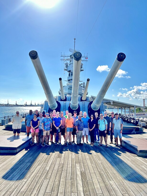 The INDOPACOM JCWS Satellite Seminar 27, nicknamed “The Sheepdogs,” with honorary Sheepdog, USS Missouri Historian Neil Yamamoto, in a photo taken at the end of the Staff Ride under the Missouri’s forward sixteen-inch guns.